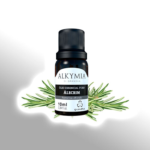 Frasco de óleo essencial puro de alecrim da linha Alkymia di Grandha, com ramos de alecrim ao fundo em destaque sobre fundo branco.